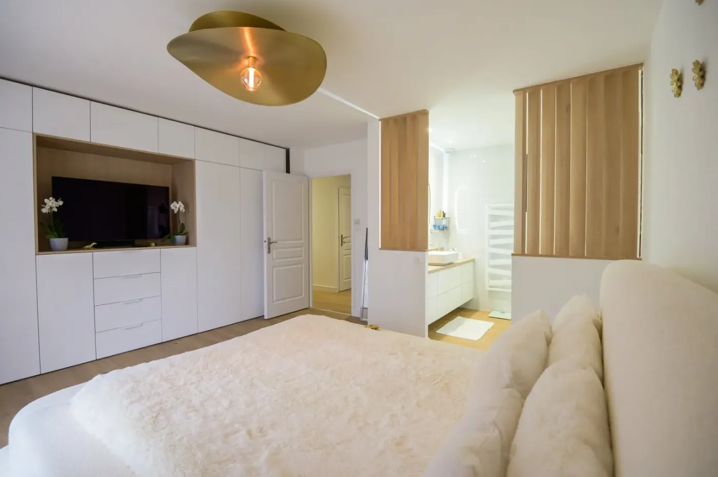 Chambre avec agencement sur mesure, comprenant un meuble TV et des claustra bois, réalisation par Ambiance Cuisine à Ruelle sur Touvre - Cuisiniste en Charente